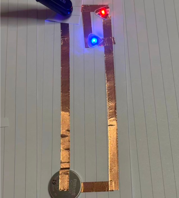 Prototype 3: Constructing an interactive circuit prototype using two LEDs, connected via battery and copper tape.