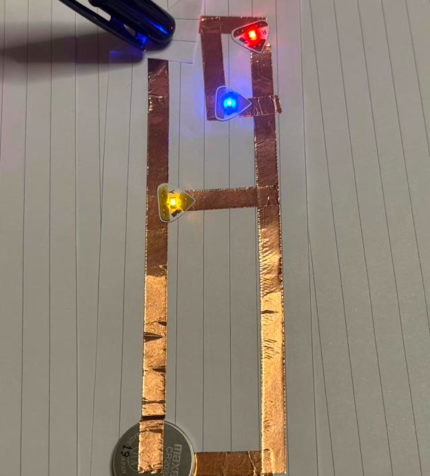 Prototype 3: Constructing an interactive circuit prototype using three LEDs, connected via battery and copper tape.